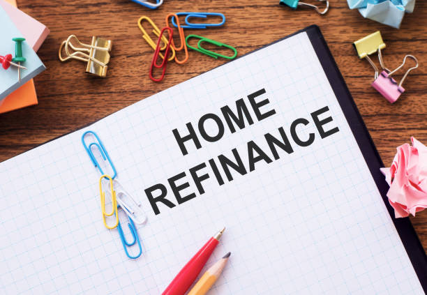 istock Notepad with text Home Refinance on wooden background with paper clips and pen 1385703066