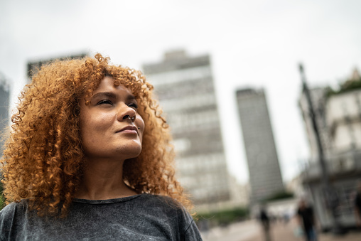 Contemplative mid adult woman in the city