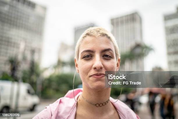 Portrait Of A Young Woman In The Street Stock Photo - Download Image Now - Shaved Head, One Woman Only, Blond Hair
