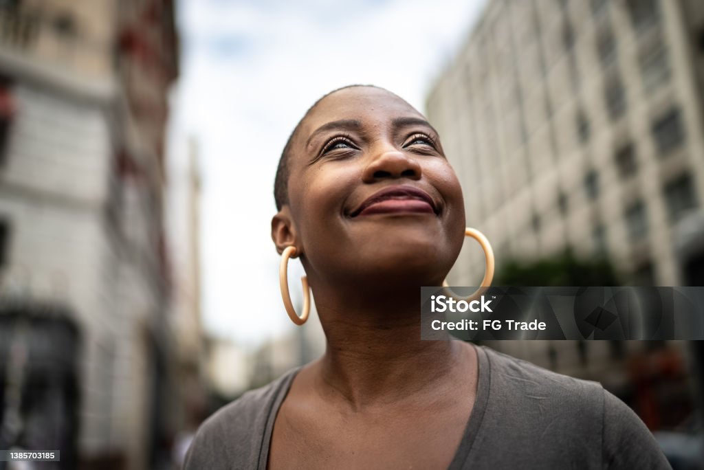 Contemplative mid adult woman in the street Motivation Stock Photo