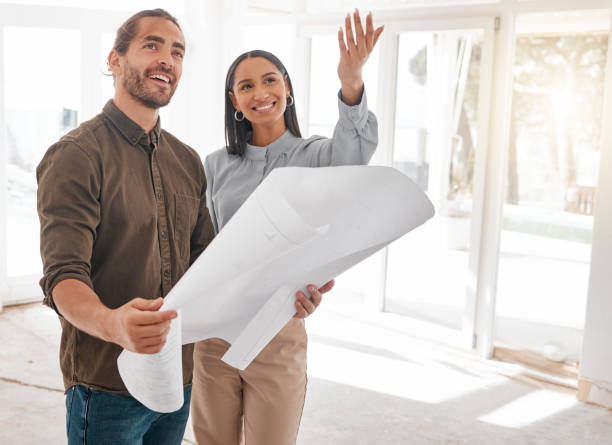 istock Shot of two young architects looking at building plans on site 1385705456