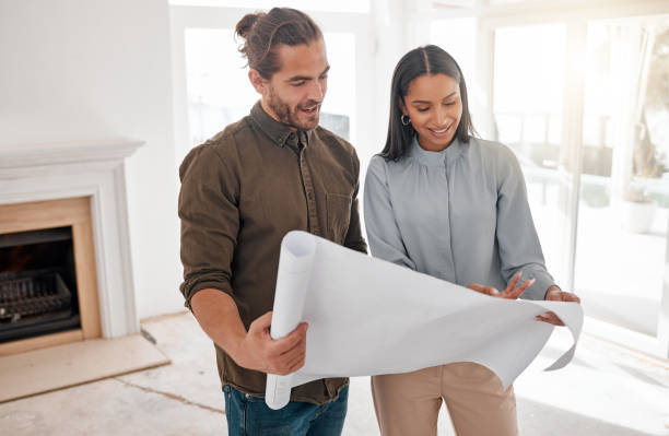 istock Shot of two young architects looking at building plans on site 1385705461