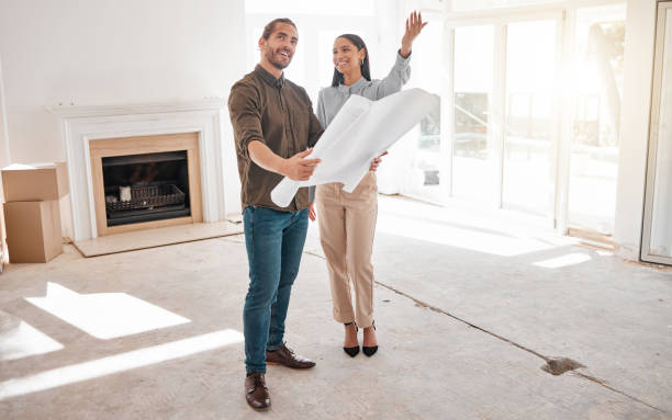 istock Shot of two young architects looking at building plans on site 1385705463