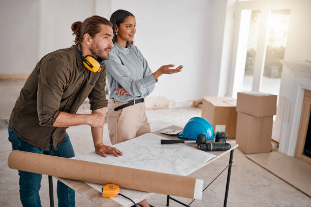 istock Shot of two young architects looking at building plans on site 1385705465