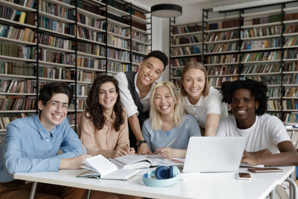 istock Portrait of joyful six multiethnic students working on project. 1385706069