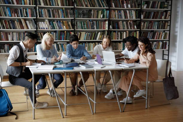istock Concentrated team of multiethnic students studying in library. 1385706077