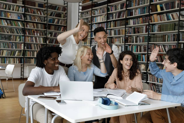 istock Cheerful young multiethnic students giving high five to each other. 1385706082