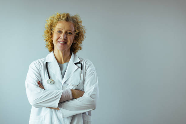 istock Confident doctor standing arms crossed 1385706124