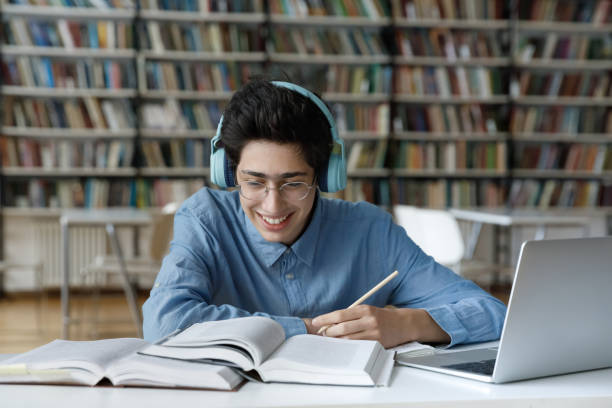 istock Happy millennial Jewish male student studying in library. 1385706126