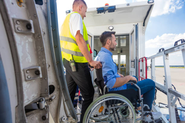 istock Service man helping disabled passenger to enter on board at airport 1385706181