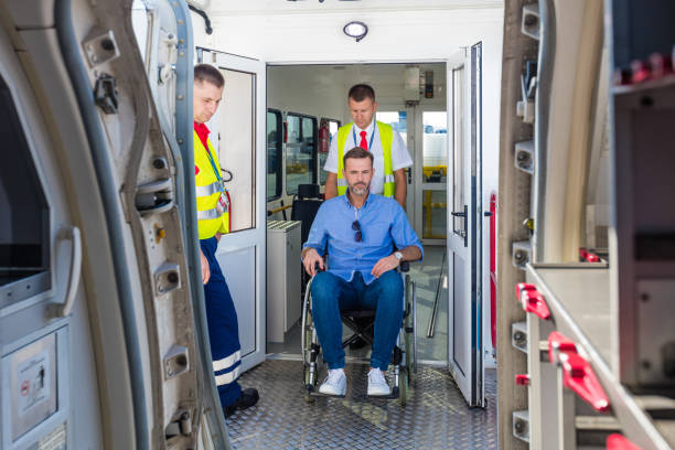 istock Service man helping disabled passenger to enter on board at airport 1385706203