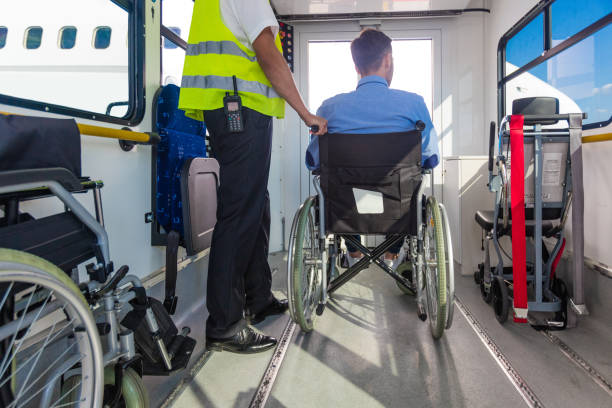 Service man helping disabled passenger to enter on board at airport Ground service men helping wheelchair passenger to enter on airplane board, they using an elevator. accessibility for persons with disabilities photos stock pictures, royalty-free photos & images