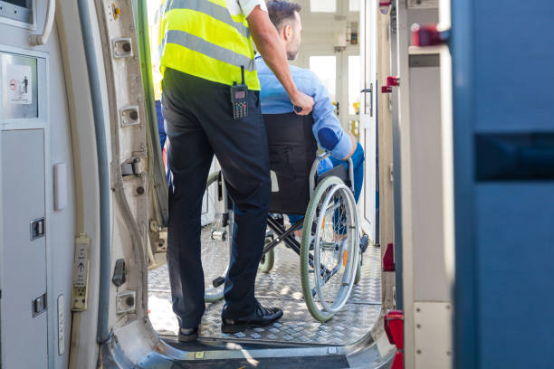 Service man helping disabled passenger to enter on board at airport