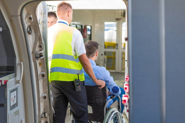 istock Service man helping disabled passenger to enter on board at airport 1385706268