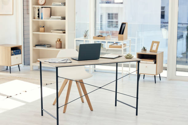 istock Shot of an empty office with a laptop on the table 1385706822