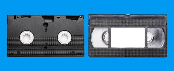 istock Black vhs tape isolated on blue. Outdated technology background. 1385708325