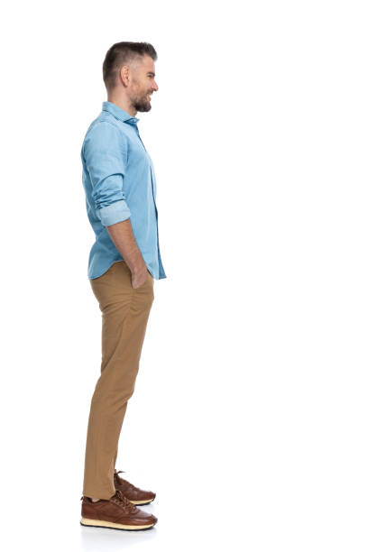 istock happy bearded guy with hands in pockets standing in line and smiling 1385708335