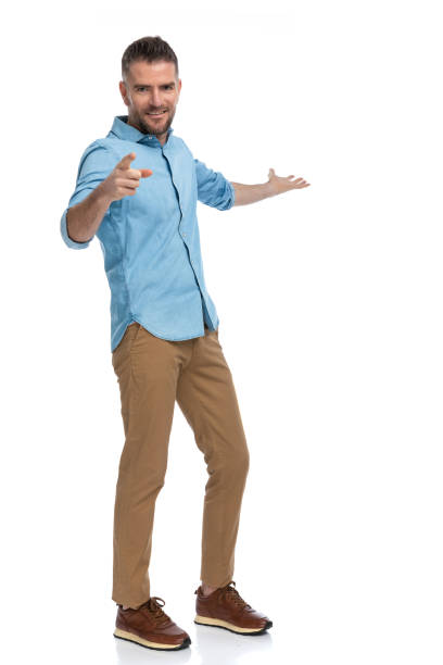 istock attractive young man pointing finger and presenting to side 1385708364