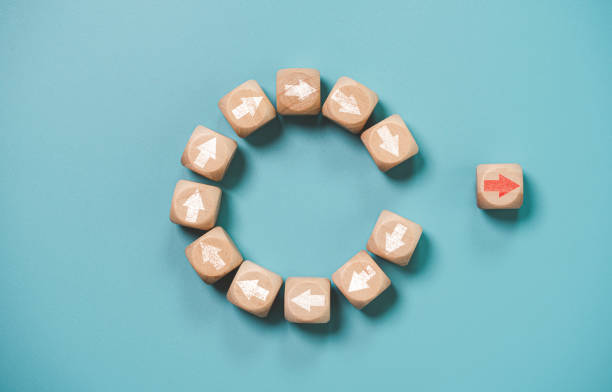 istock Disruption and technology transformation concept , Red arrow on wooden block cube move out from circle white arrow on blue background. 1385708563