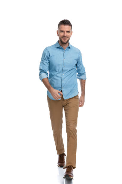 istock confident unshaved man in casual outfit walking and smiling 1385708569
