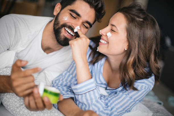 Skin care and fun in the bed. stock photo