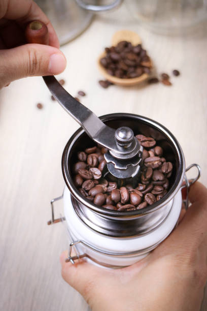 istock A roasted coffee bean in a metal manual grinder 1385710033