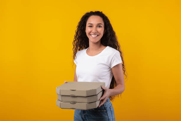 istock Happy Latin Lady Holding Pizza Boxes At Studio 1385710226