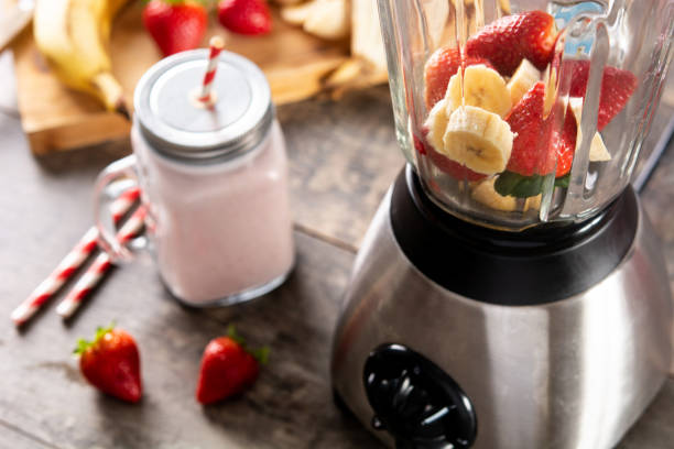 istock Preparing strawberry and banana smoothie in mixer 1385710321