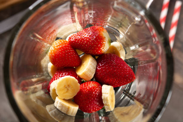 istock Preparing strawberry and banana smoothie in mixer 1385710345