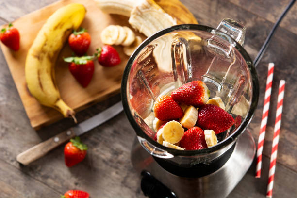 istock Preparing strawberry and banana smoothie 1385710383