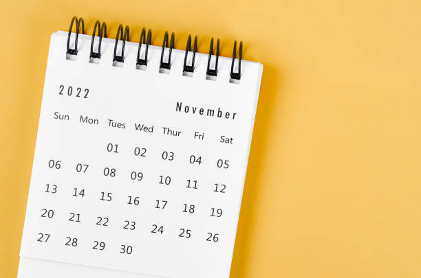 istock November 2022 desk calendar on light yellow background. 1385713420