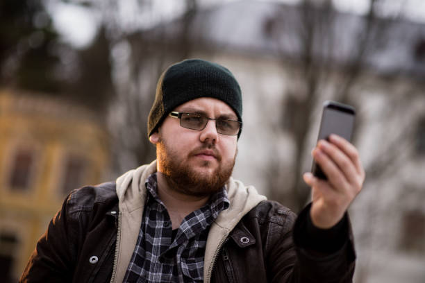 istock Man using phone in the city 1385715115