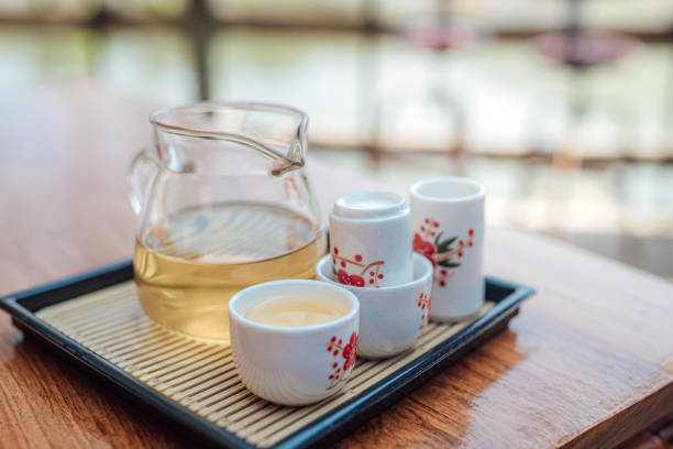 Tea in glass with tea jug set on the wooden table, Chinese and Japanese cultures. stock photo