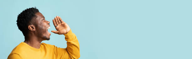 istock Happy black guy saying something out loud, copy space, banner 1385716216