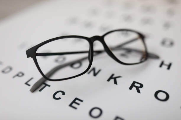 istock Glasses for sight lie on the table on the alphabet 1385716934