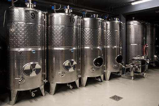 Row of Stainless Wine Tanks in Wine Cellar.