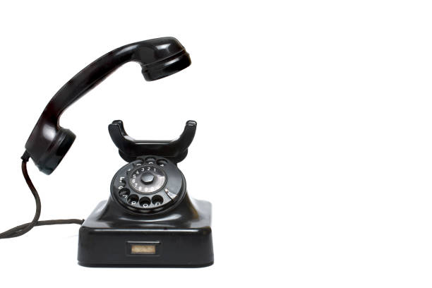 istock Closeup vintage phone lifted earpiece white background 1385717251