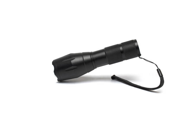 istock Closeup black aluminum flashlight outdoor white background 1385718068