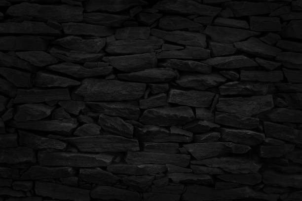 istock Black stone brick wall texture in natural pattern for background and design art work. 1385718961
