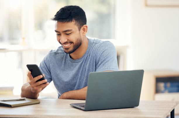 istock Shot of a young businessman using a phone in an office at work 1385720669