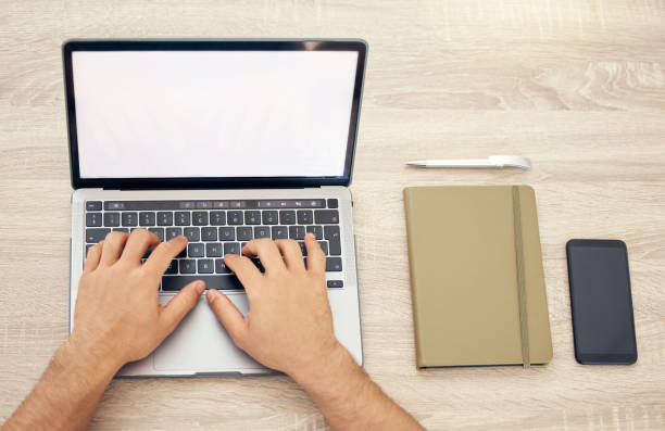 istock High angle shot of an unrecognizable person using a laptop in an office 1385720982