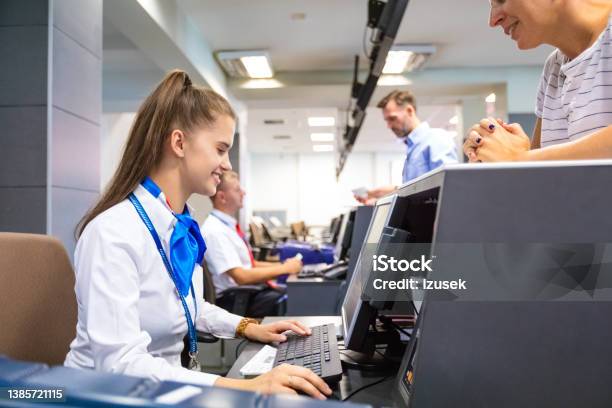 Airline Attendant Doing Checkin For Flight At Airport Stock Photo - Download Image Now