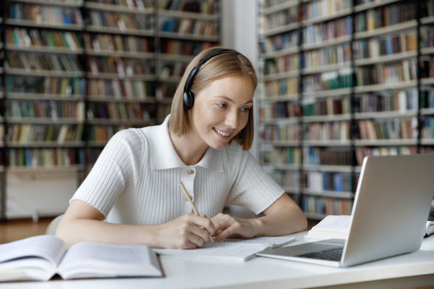istock Happy young beautiful female student watching educational lecture. 1385721365