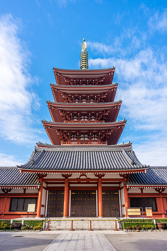 Tokyo, Japan - December 21, 2020 : Japanese Buddhist five-storeyed pagoda is at Senso-ji Temple. This monastery is oldest ancient Buddhist temple located in Asakusa. It is famous place and and one of the most significant in Tokyo, Japan