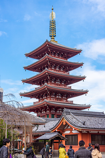 Tokyo, Japan - December 21, 2020 : Japanese Buddhist five-storeyed pagoda is at Senso-ji Temple. This monastery is oldest ancient Buddhist temple located in Asakusa. It is famous place and and one of the most significant in Tokyo, Japan