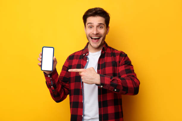 istock Man showing white empty smartphone screen and pointing finger 1385723447