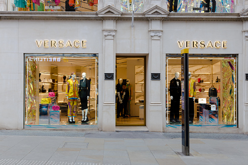 London, UK - 14 March, 2022: exterior architecture of a Versace luxury store outdoors on a city street in central London, UK.