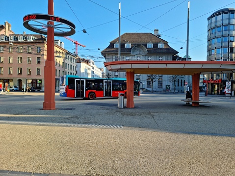Biel / Bienne with the Zentralplatz (place centrale). The image shows the city square with a bus stop building during late afternoon.