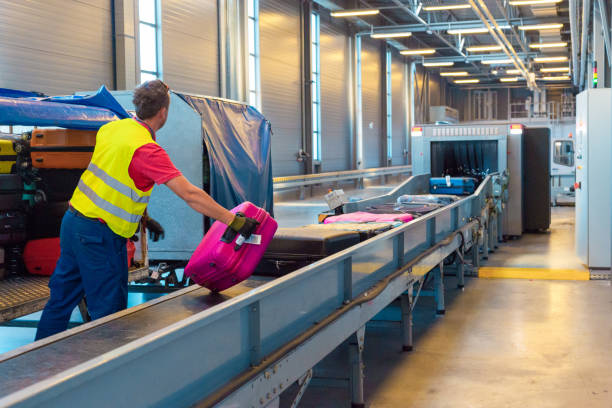 istock Airport service crew unloading luggage 1385727517