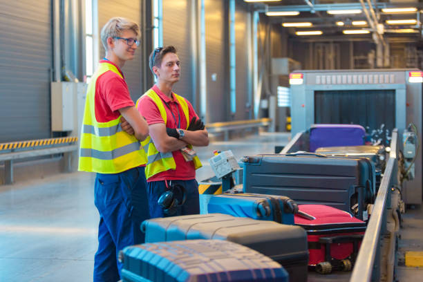 istock Airport service crew unloading luggage 1385727560